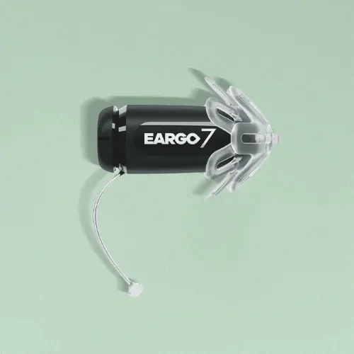 Eargo hearing aid against green background
