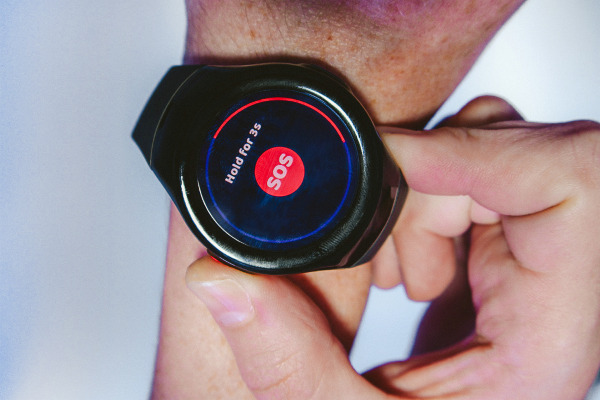 MGMove watch on wrist displays “Hold for 3s” message as the wearer’s thumb presses the side red button