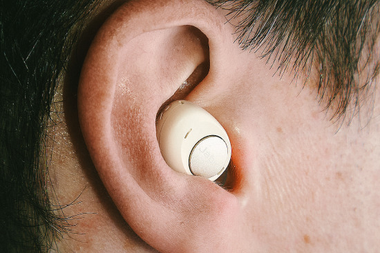 The large earbud-style Jabra Enhance Plus fills the entire bowl of a person’s ear