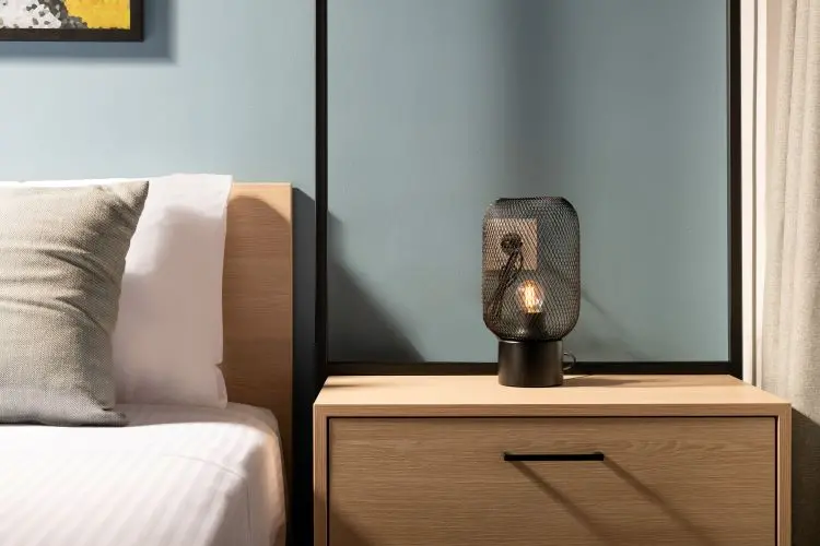 lamp on nightstand next to bed