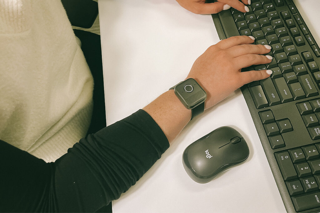 Person typing on a keyboard wearing the MGMini Lite on their wrist