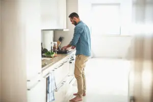 Man making a meal in his kitchen